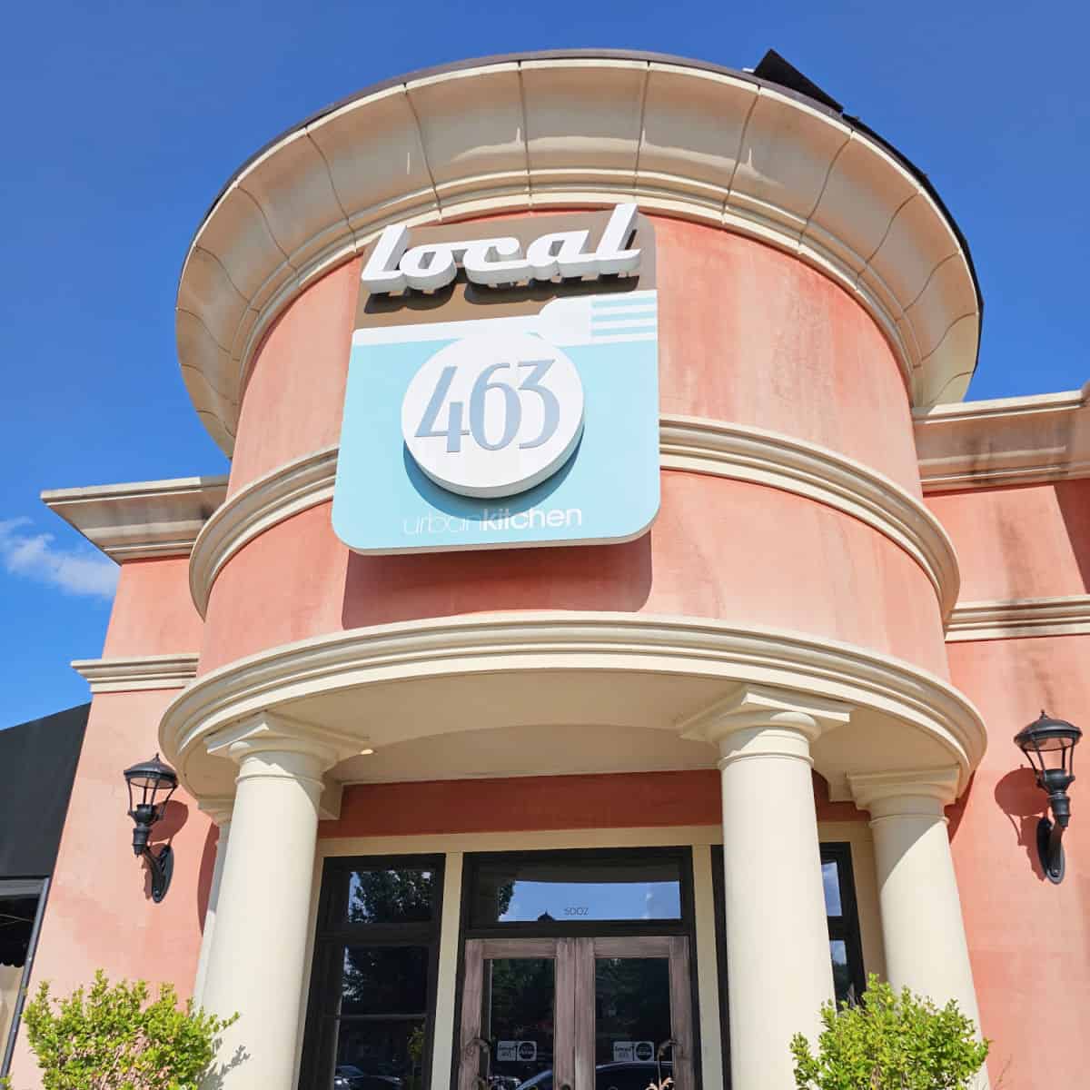 Local 463 sign on a pink brown building over the main entrance