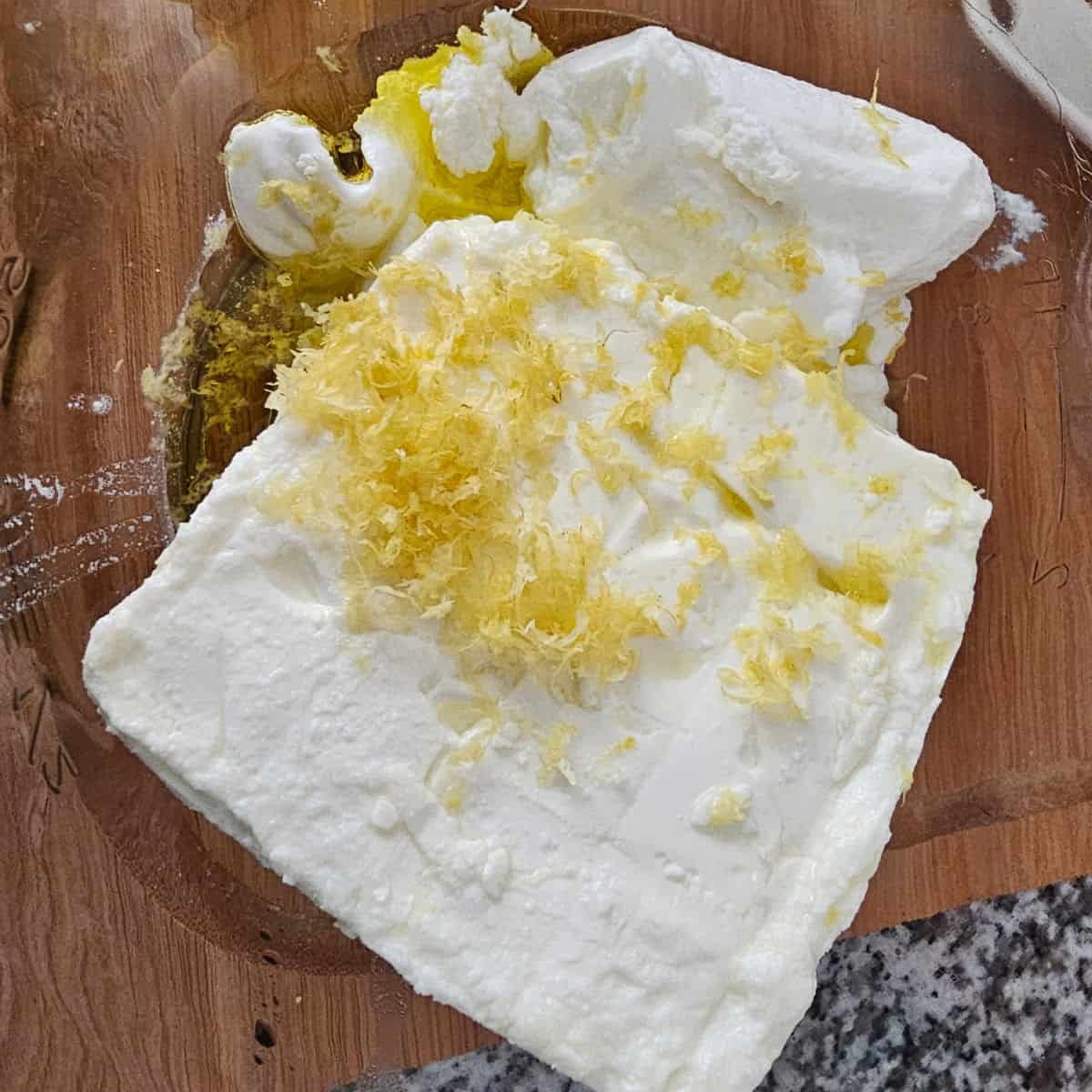 feta, yogurt, lemon zest, and olive oil in a glass bowl